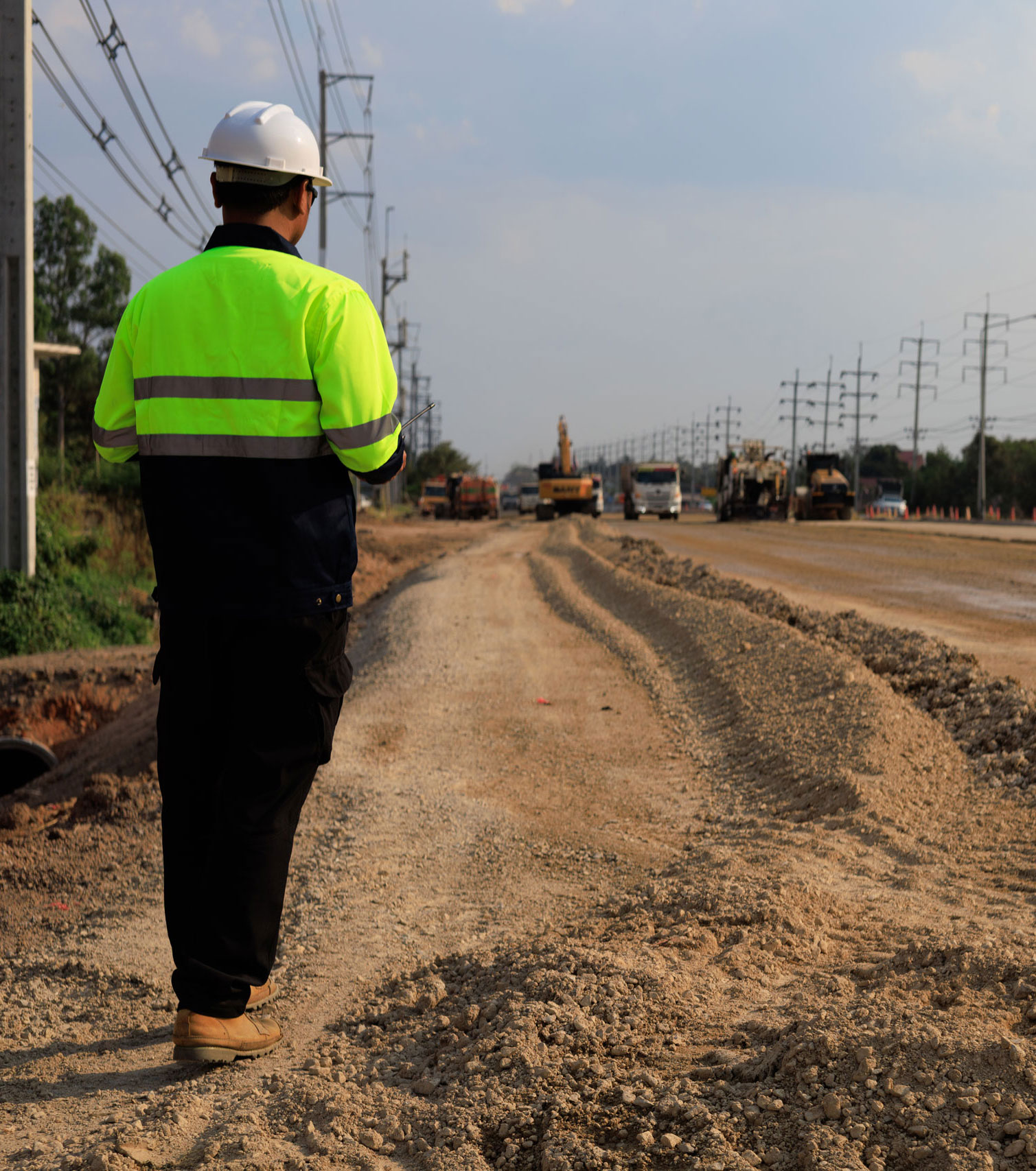 Employee surveying a new site for construction